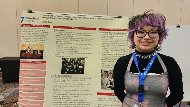 Sarah next to her poster