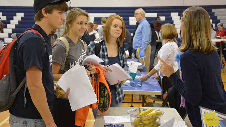 Students getting advice and bananas at WHAM event