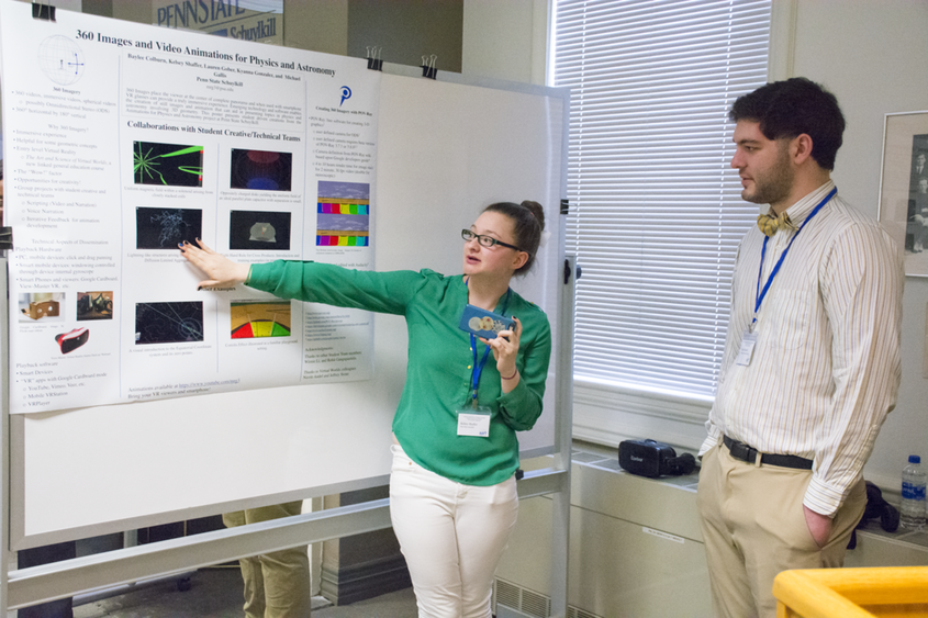 During a research poster session at a Physics Conference, Kelsey Shaffer demonstrates a lightning fractal effect in 3D by using a smartphone.