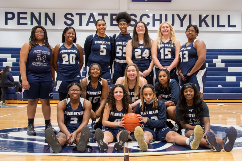 The Penn State Schuylkill women's basketball team poses at mid-court in the gymnasium.