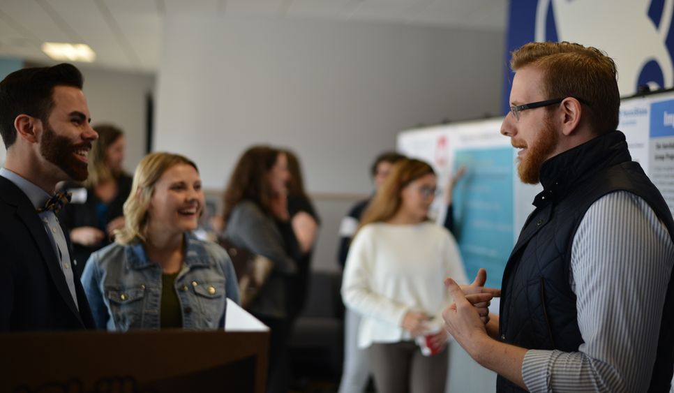 Matthew giombetti discussing his research project with other students