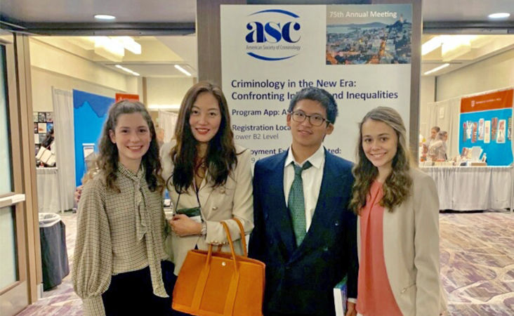 Four people stand in front of a sign that reads "ASC 75th Annual Meeting"