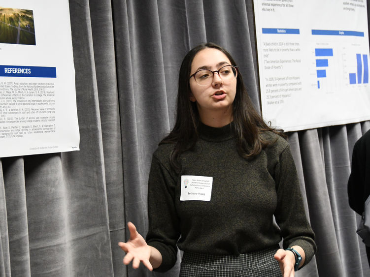Female student presents research at conference