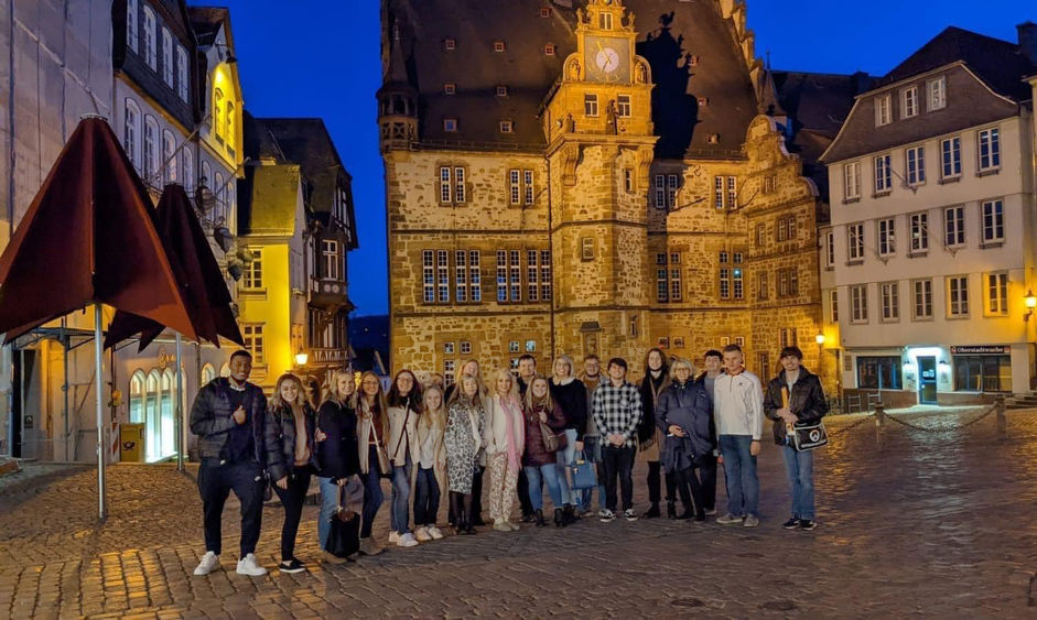 An image of Penn State Schuylkill Students posing on the cobblestone streets of historic German town.