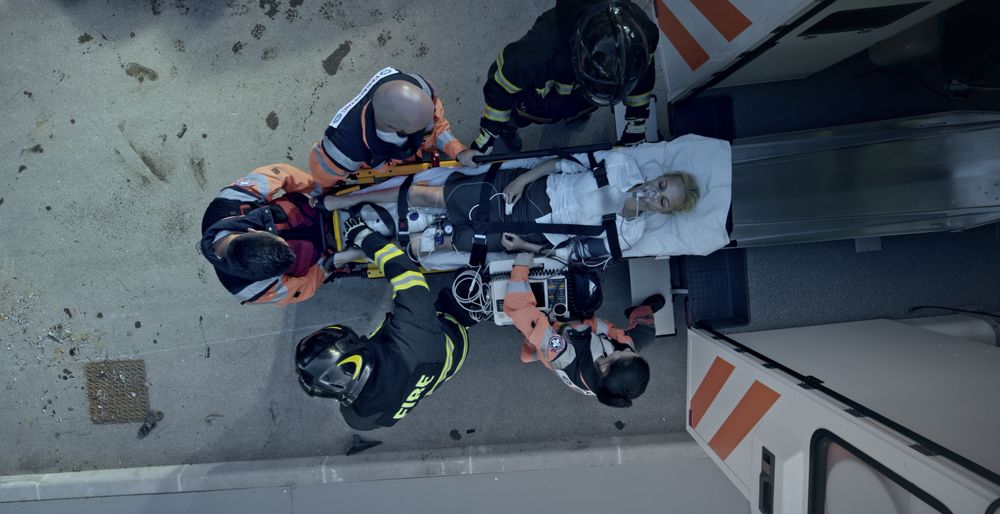 First responders lift and overdose victim into the back of an ambulance