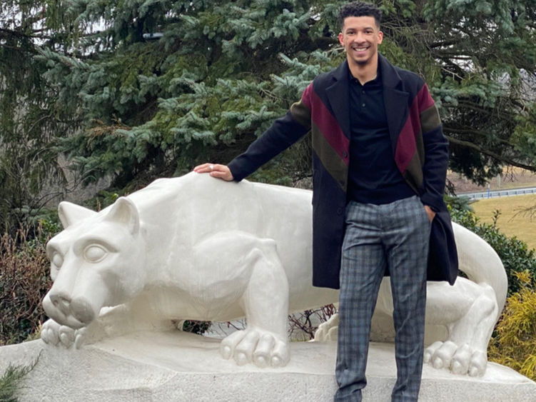 Male standing outside next the Nittany Lion Shrine