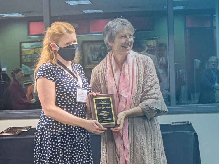 Valerie Schrader accepts a communications award