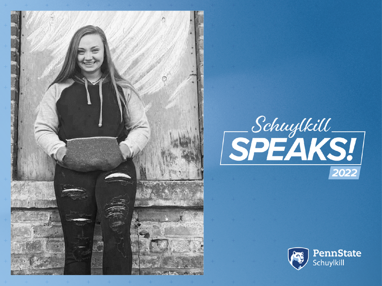 Image of female student leaning against wall with Schuylkill Speaks! graphics